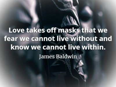 Ancient wooden head sculpture with James Baldwin quote, Love takes off masks that we fear we cannot live without and know we cannot live within.
